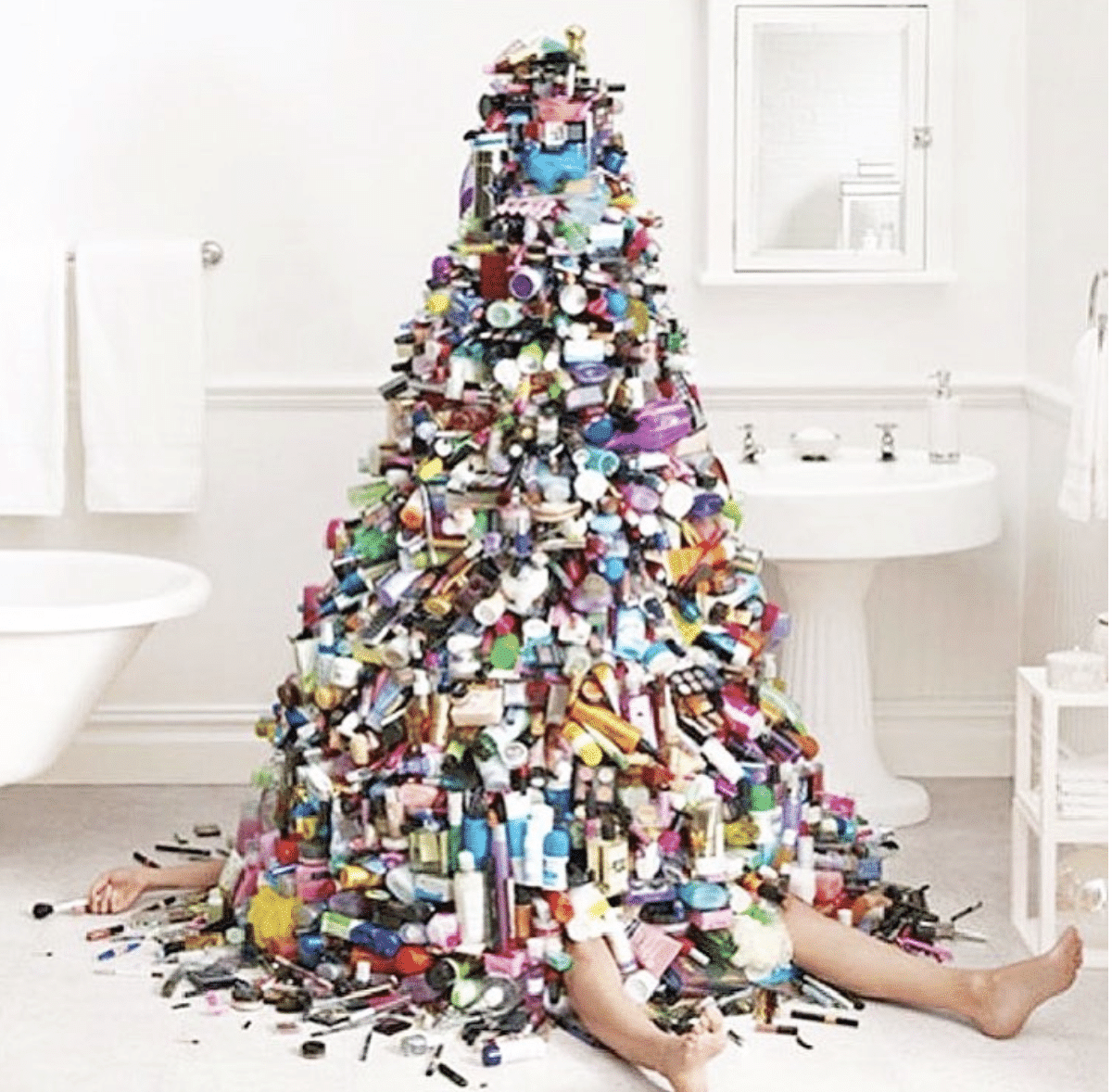 person laying under pile of toiletries