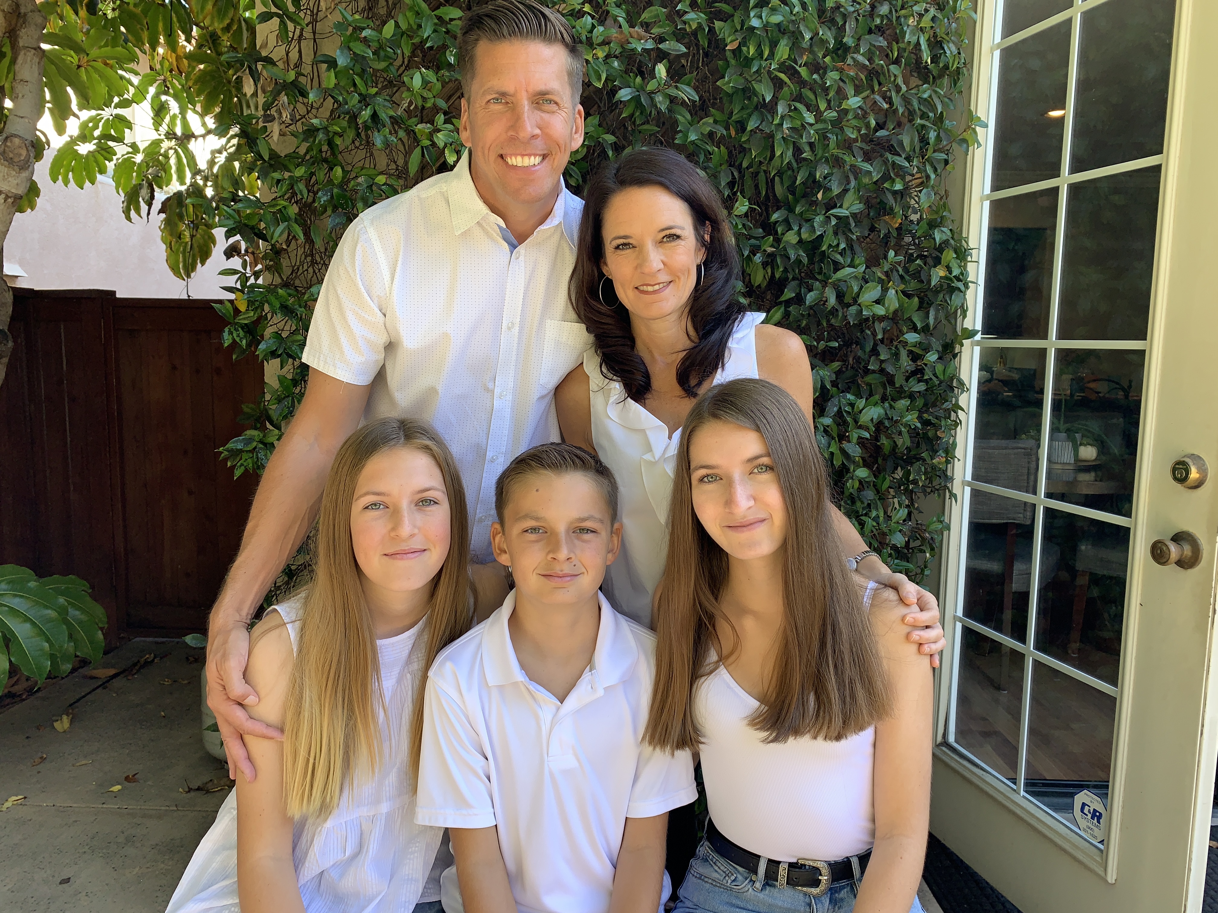 Family dressed in white in a posed photo