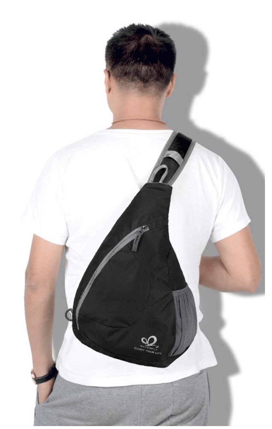 Man carrying a black travel bag/backpack 