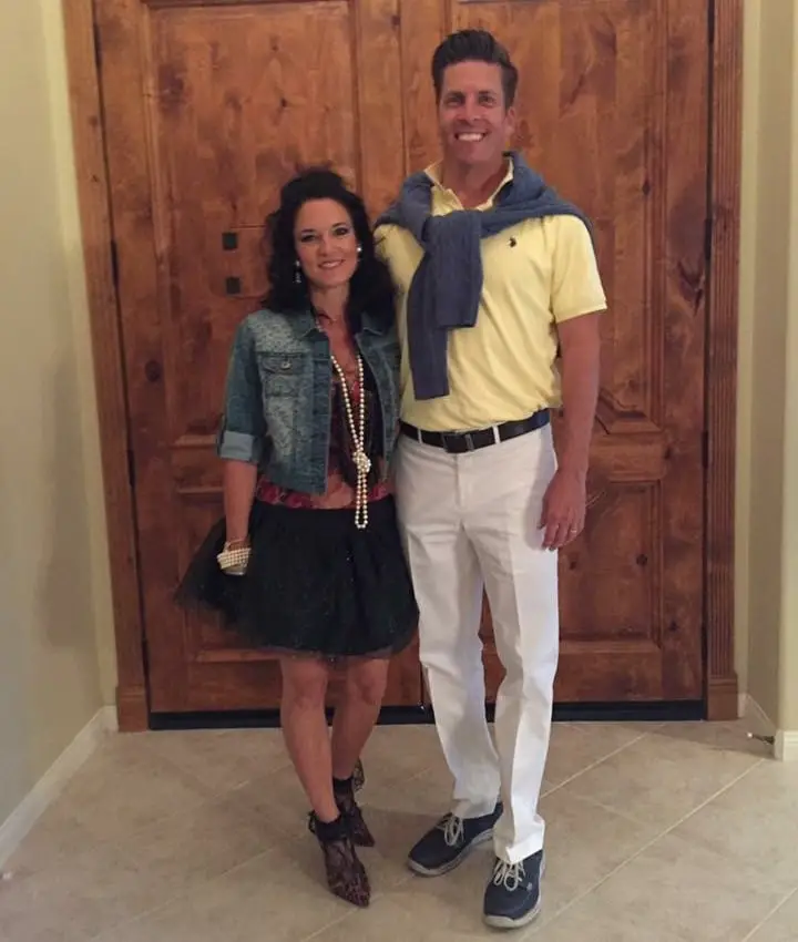 Man and woman dressed in 80s clothes for Halloween