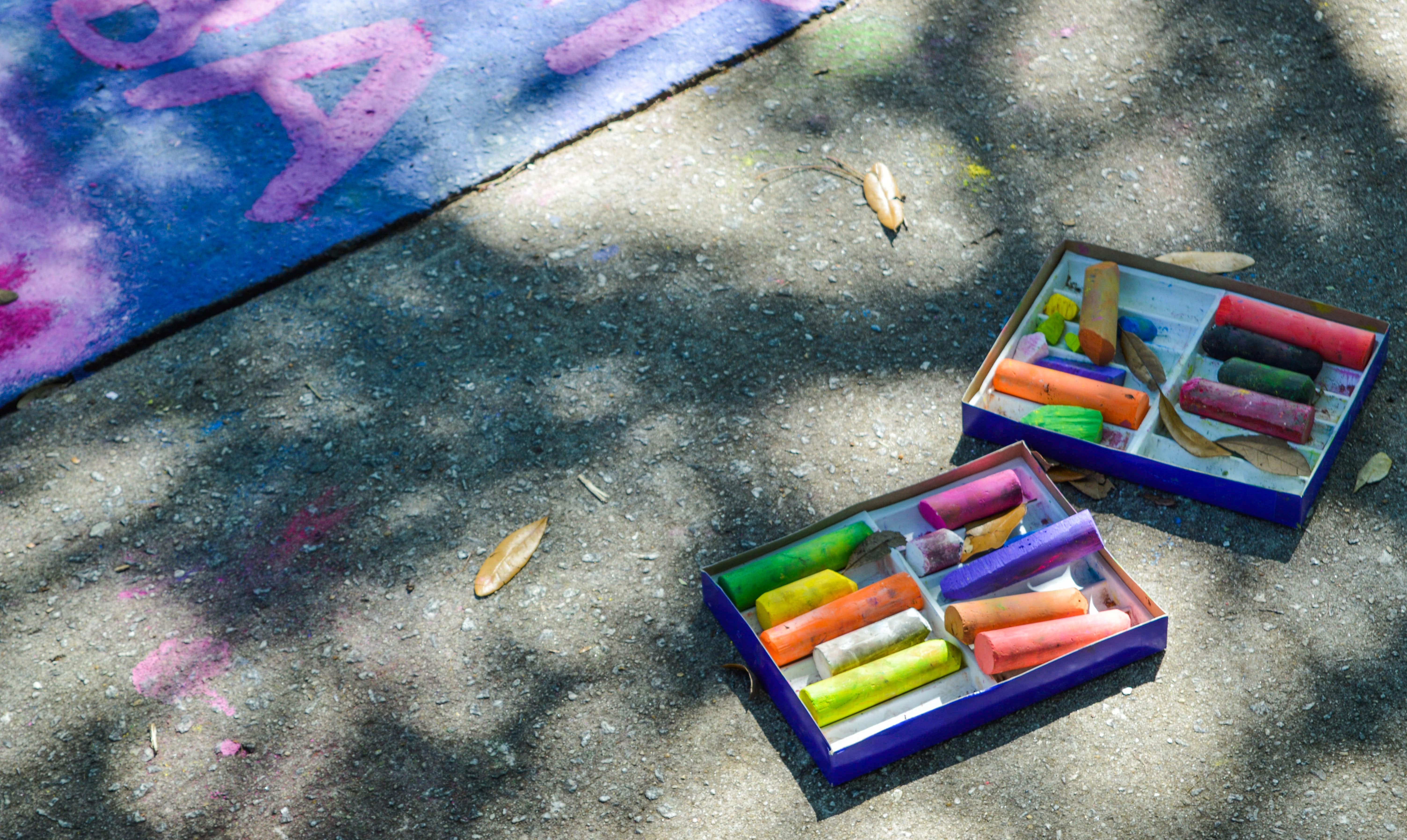 Sidewalk chalks in two boxes outside