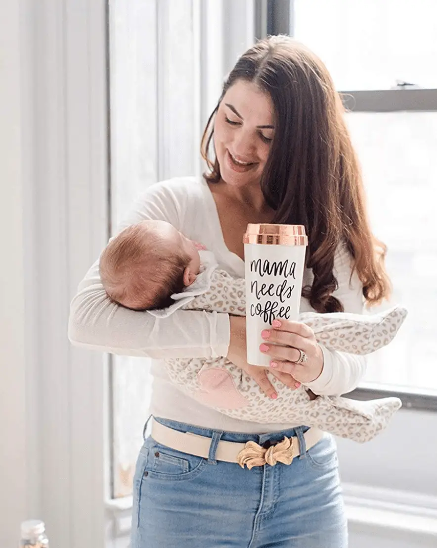 Mom drinking coffee and holding a baby