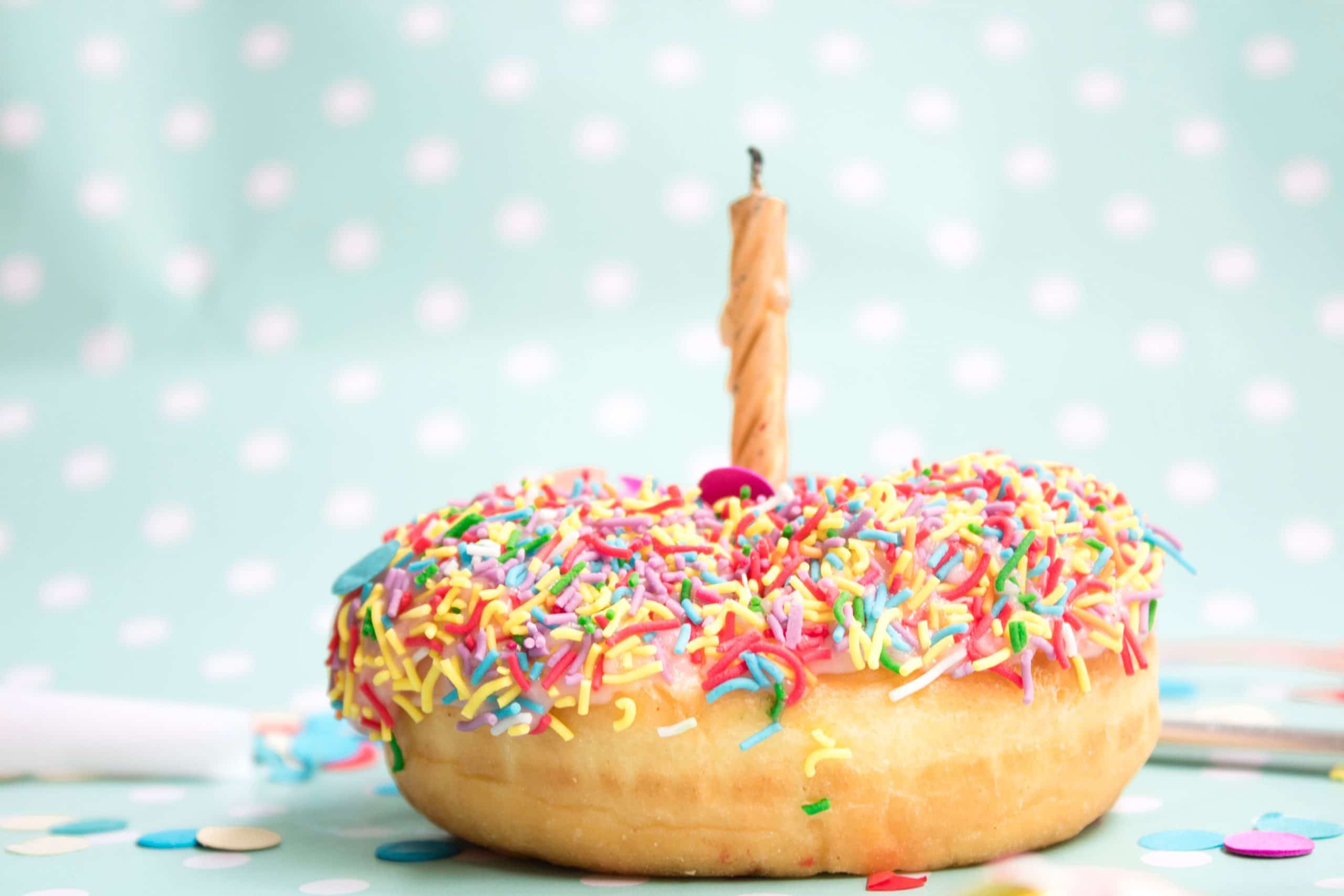 Sprinkle donut with a birthday candle - creative birthday traditions 