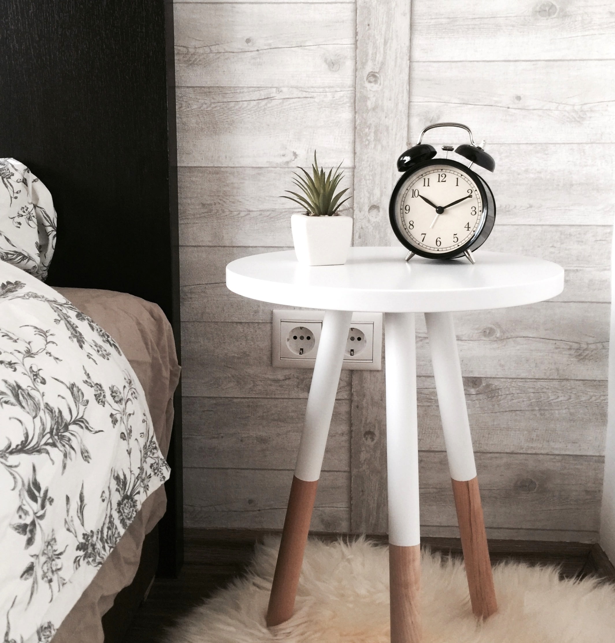 Bedroom with a clock on a bedside table