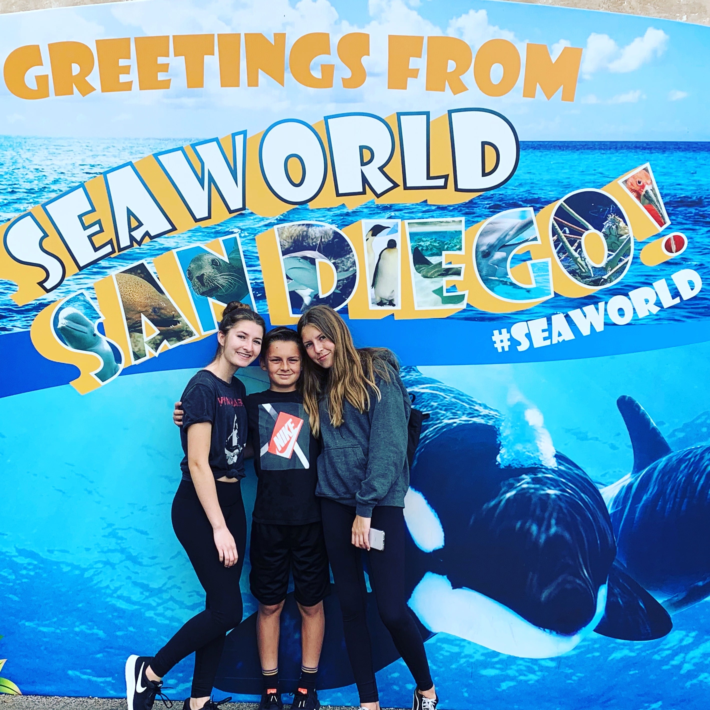 Kids posing in front of Sea World San Diego Sign