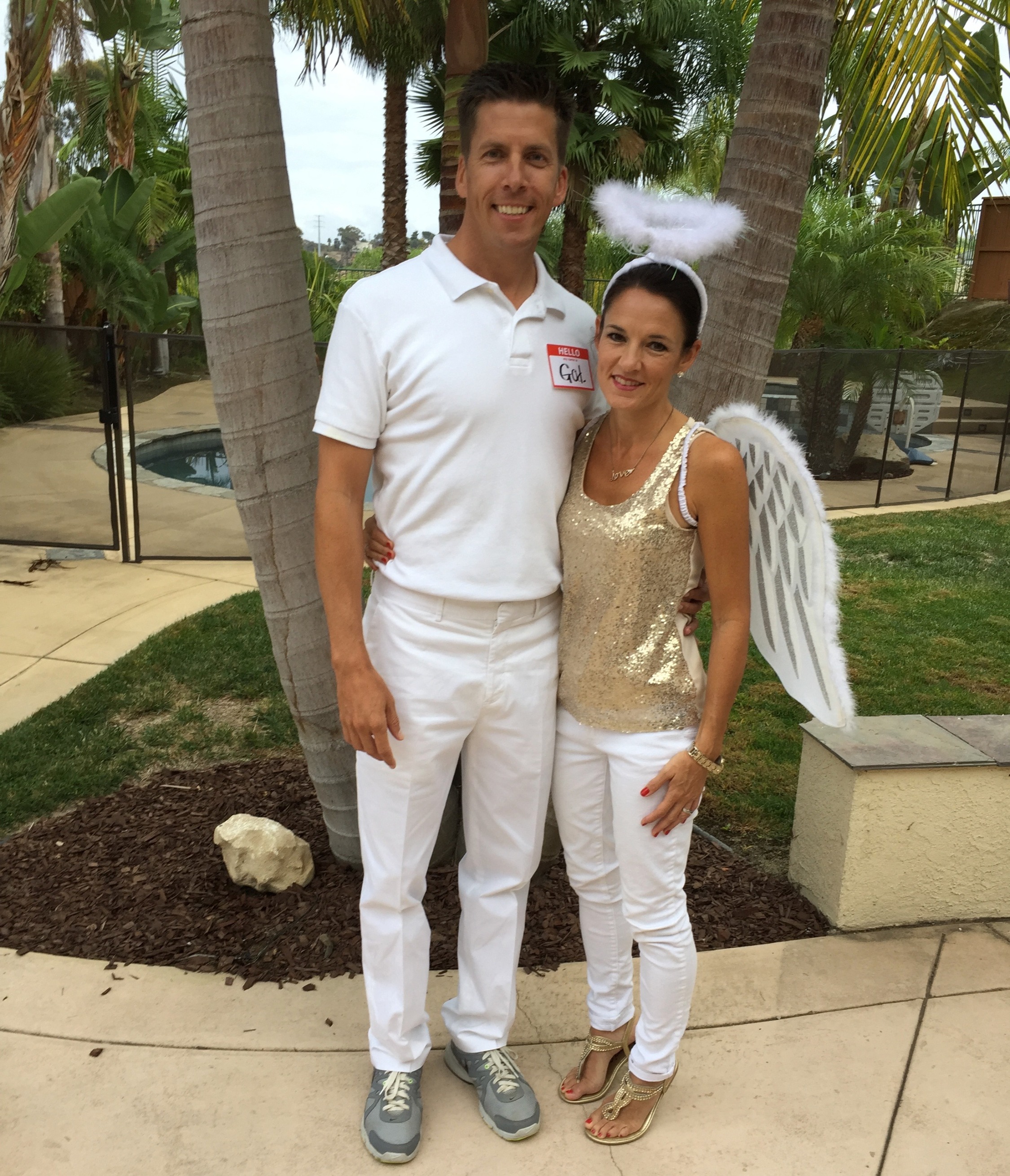 Man and woman dressed as God and an angel for Halloween 
