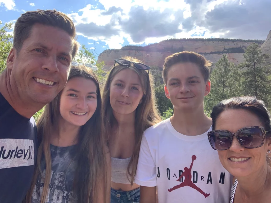 Family of five smiling in Zion Utah