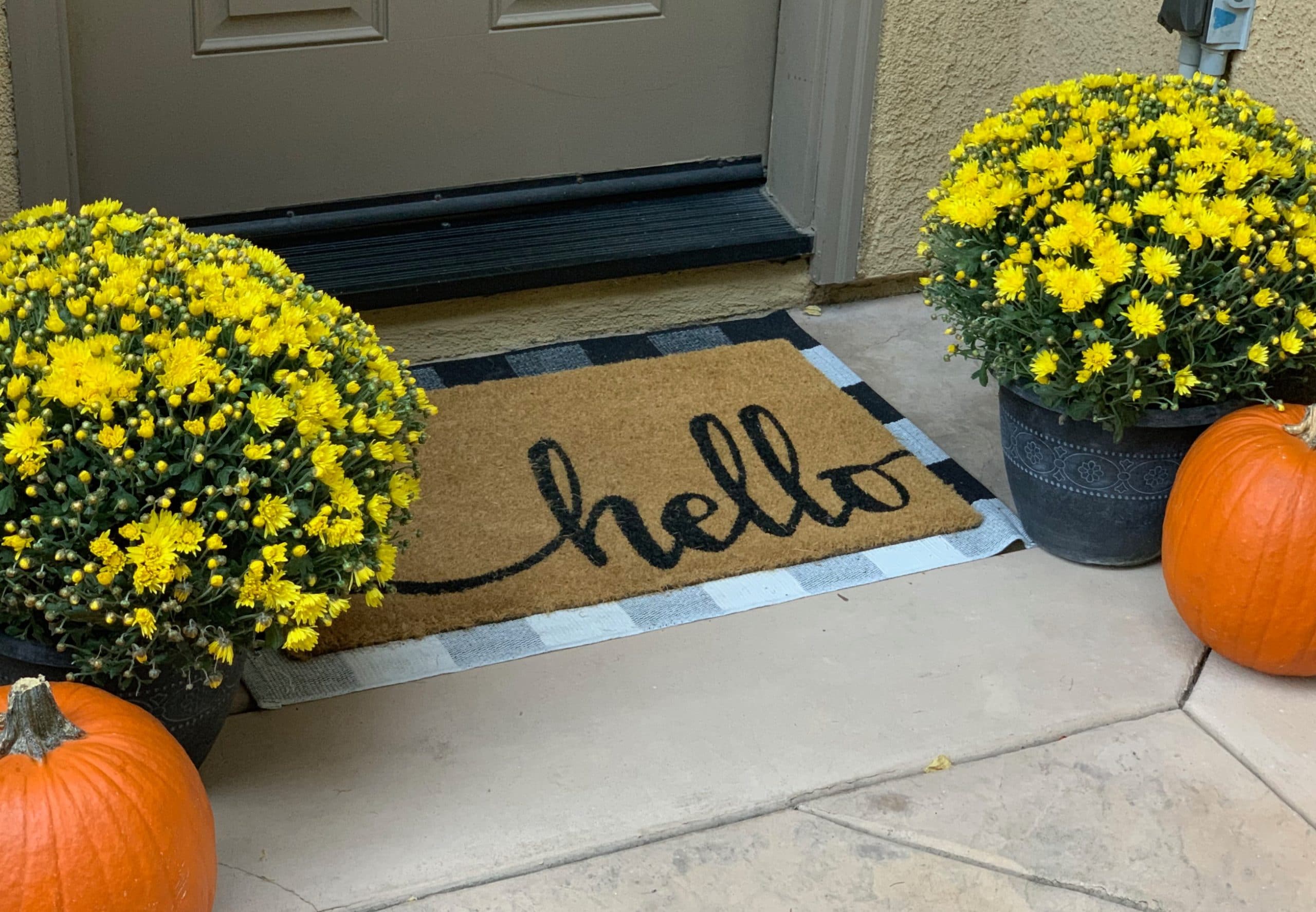 Front porch with fall mums pumpkins and hello door mat no more fear of hosting