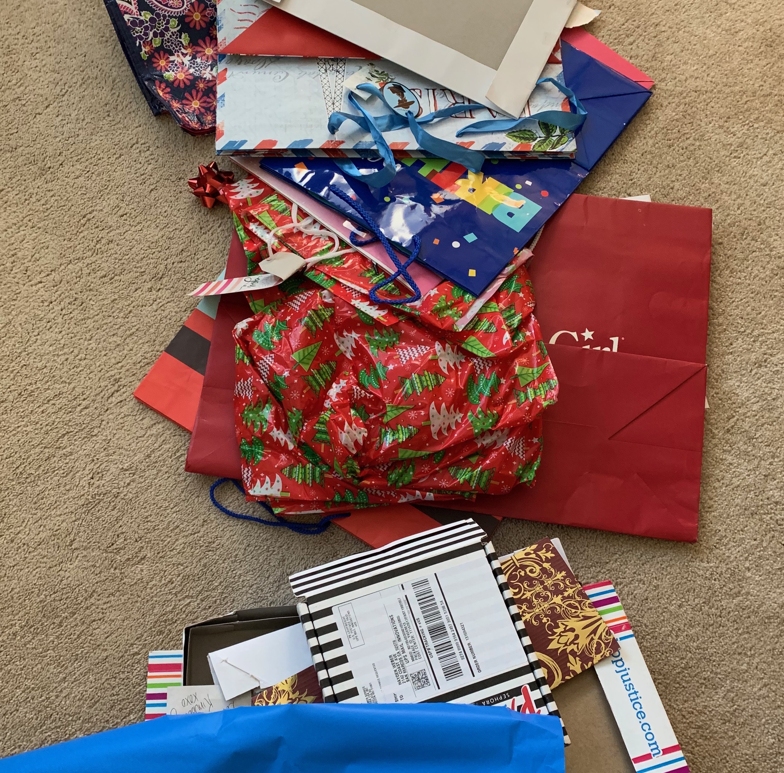 A pile of olf gift bags, boxes and wrapping paper