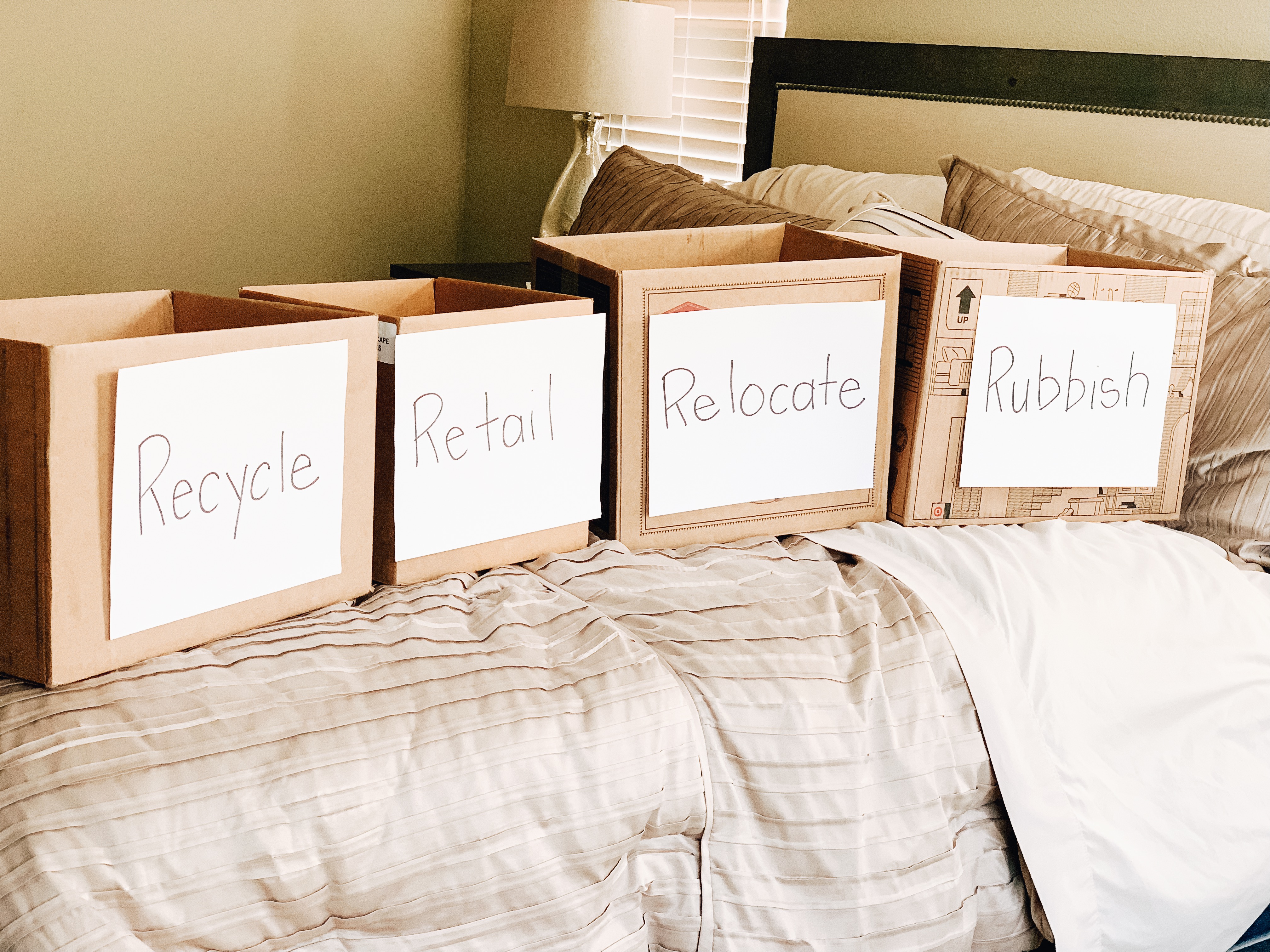 Cardboard boxes labeled for decluttering project