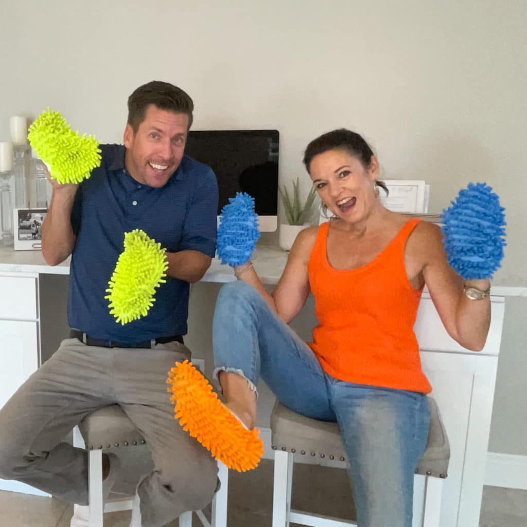 Man and woman smiling with cleaning slippers on
