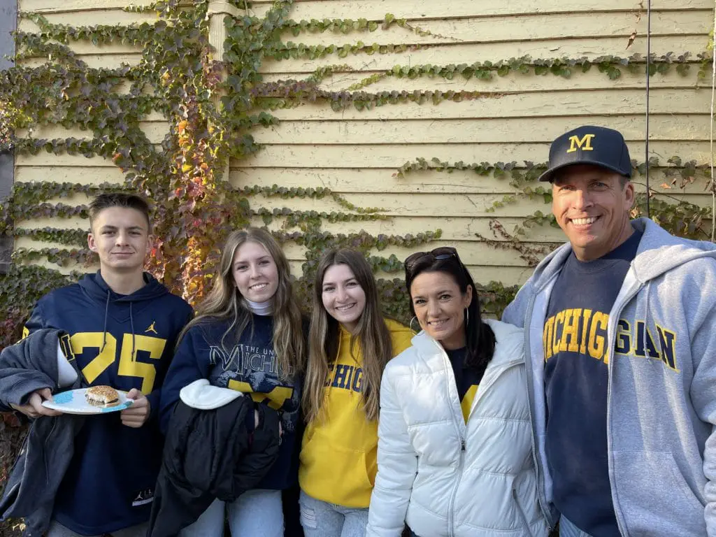 Family picture of 2 parents and 3 kids at the University of Michigan