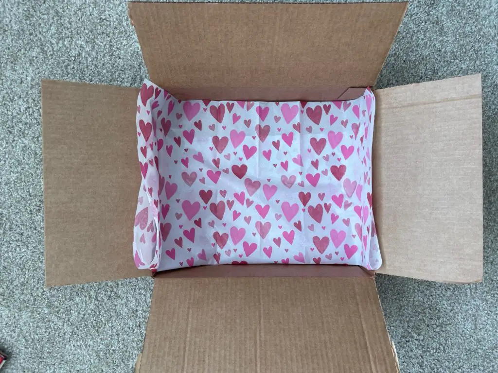 Empty cardboard box with heart tissue paper