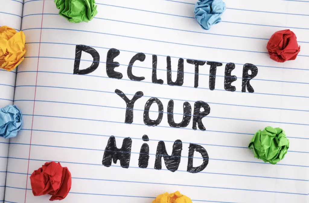 "Declutter Your Mind" Handwritten on  notebook page of paper